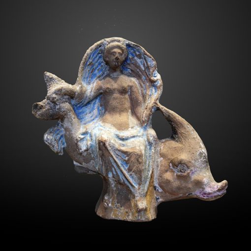 Aphrodite sitting on a Dolphin sculpture